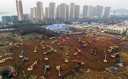 Escavadeiras em canteiro de obras de novo hospital sendo construído em Wuhan, na província central de Hubei, na China